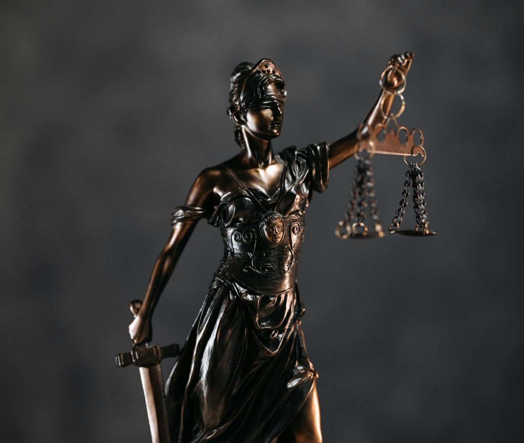 A bronze statue holding scales meant to reflect a symbol of justice