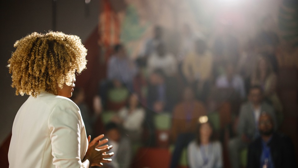 Woman speaking to an event or conference crowd